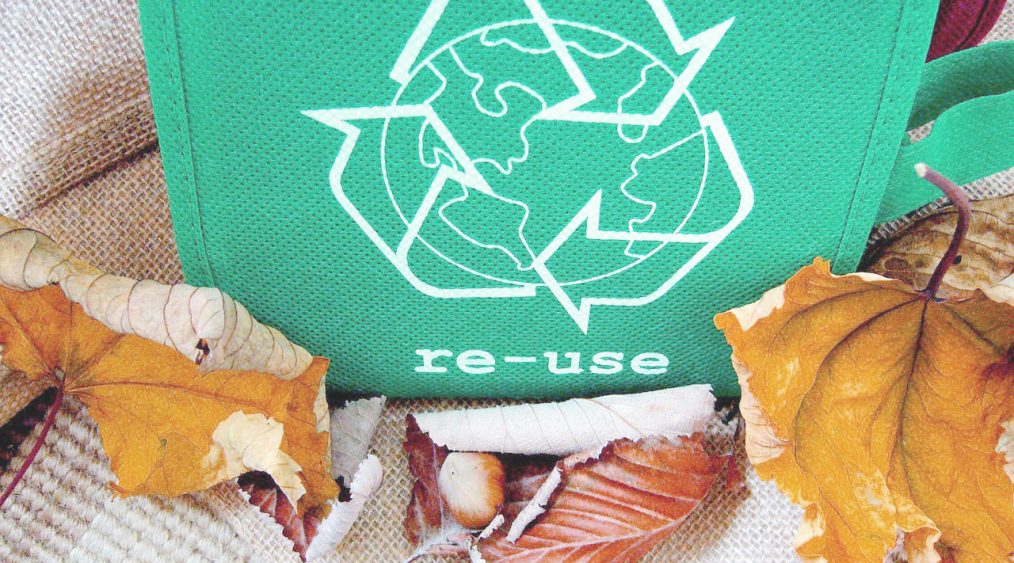 icono de re usar en una bolsa re utilizable y hojas otoñales